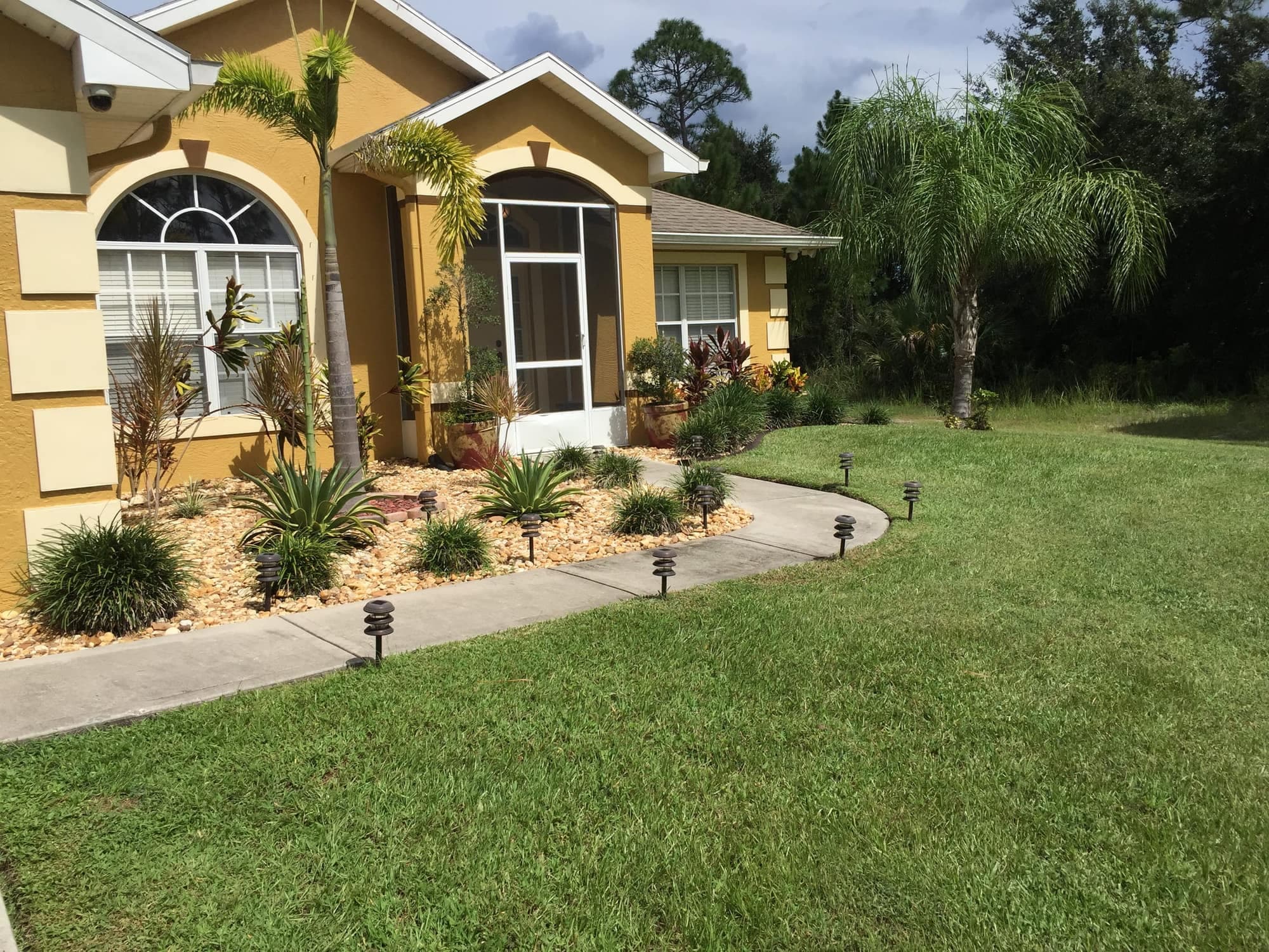 Manicured lawn and landscaped front yard in Palm Bay, FL