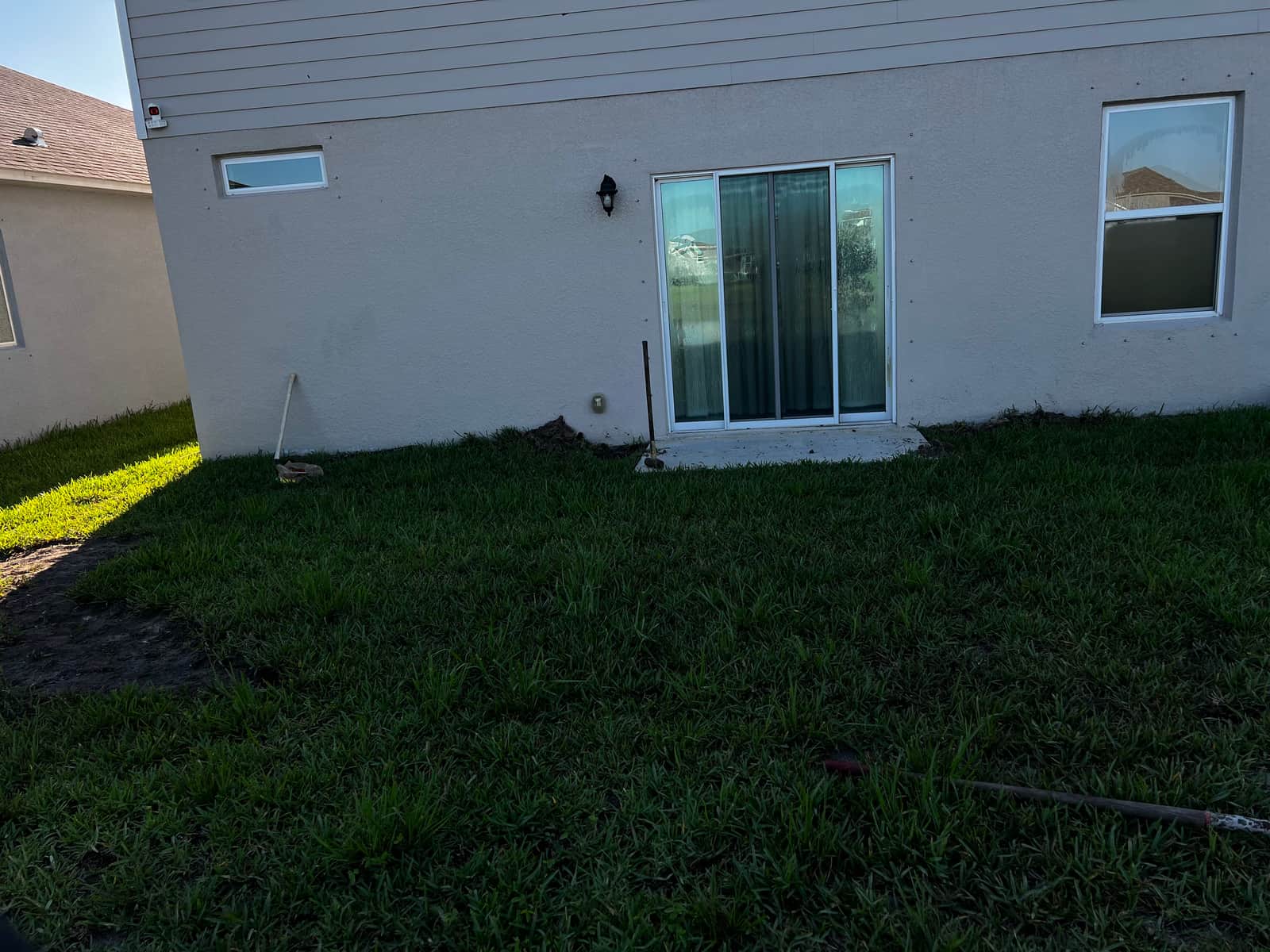 Backyard before paver patio installation — plain grass yard in Palm Bay, FL
