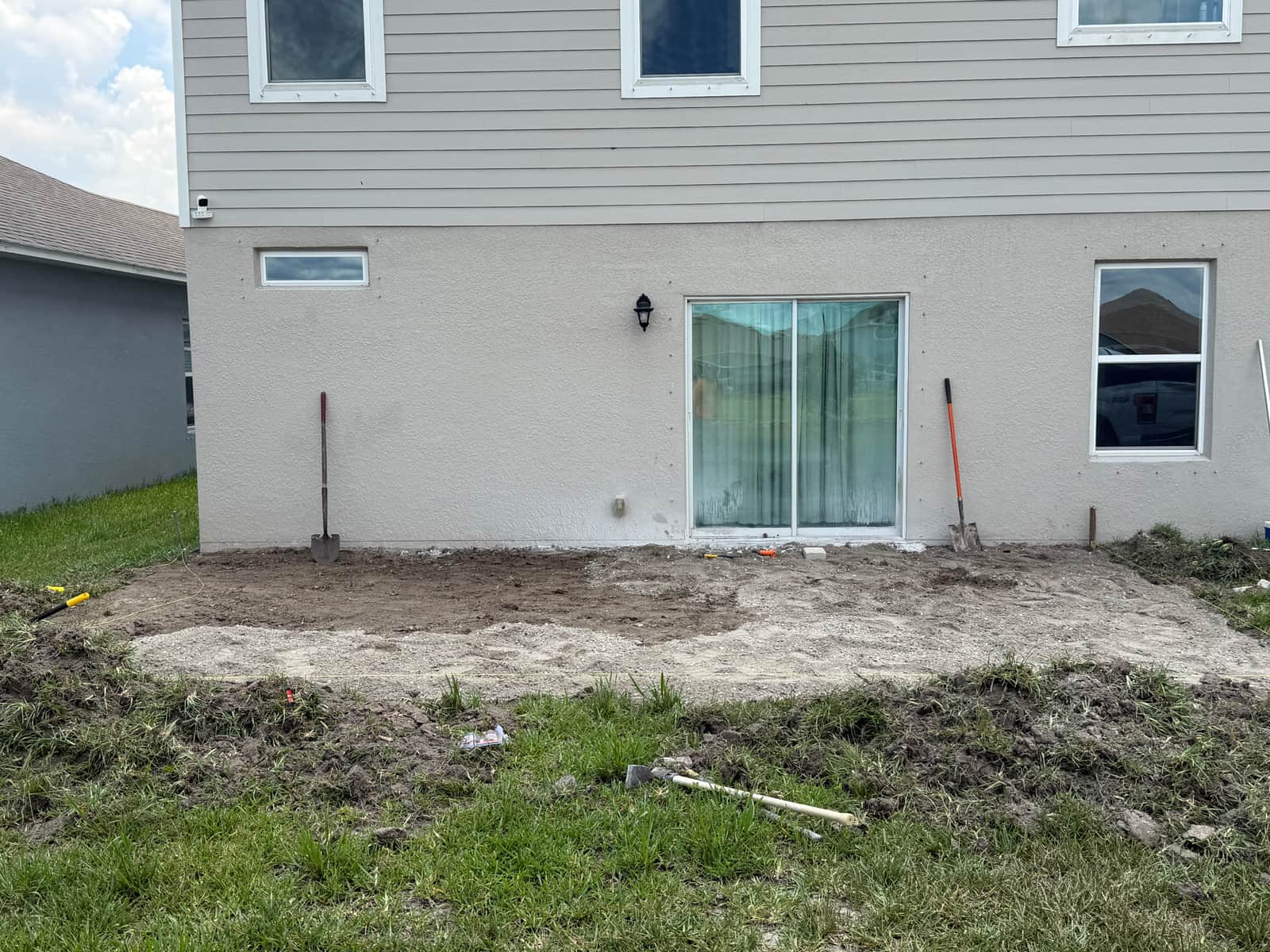Grass and sod removed and ground excavated for the new patio footprint